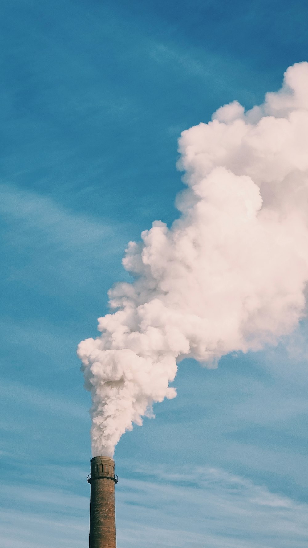 white smoke under blue sky during daytime