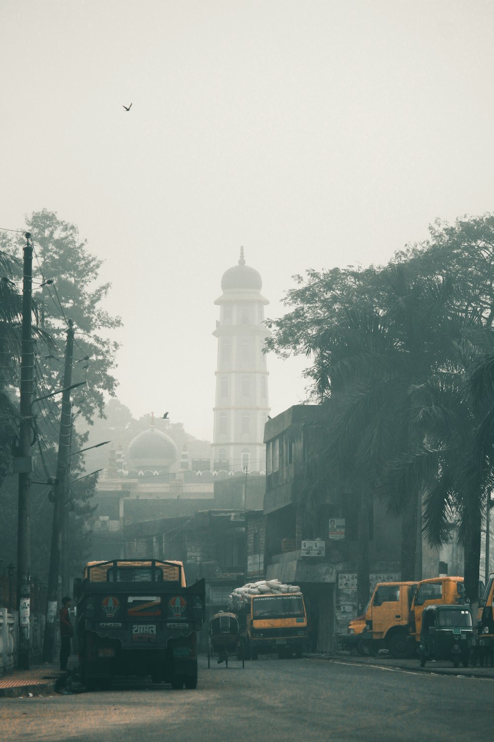 cars parked on side of the road near high rise building during daytime