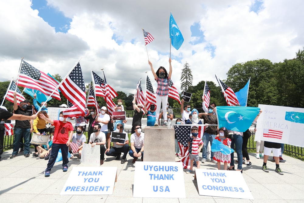 people holding flags during daytime