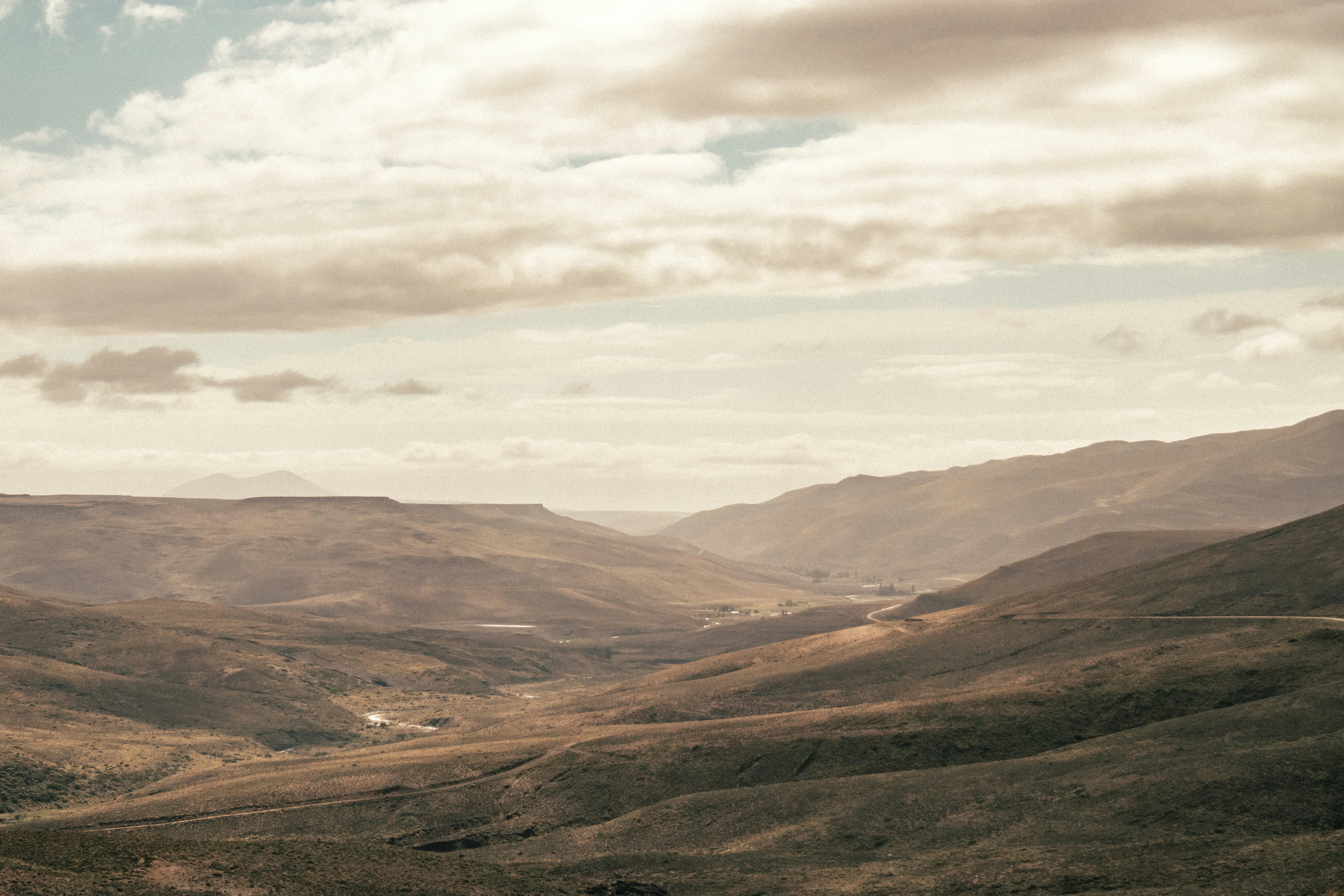 brown and green mountains under white clouds during daytime, 