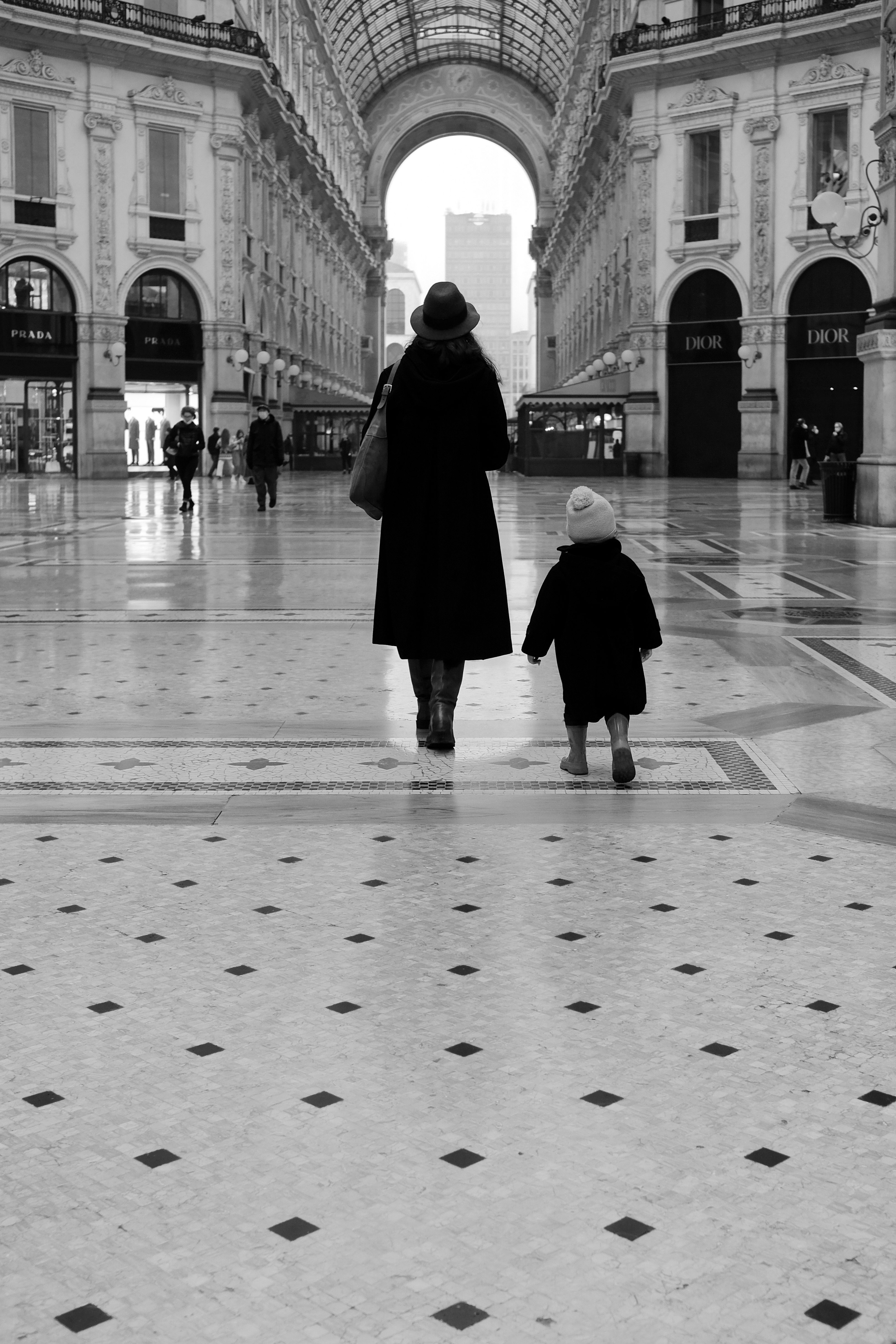 grayscale photo of person walking on street