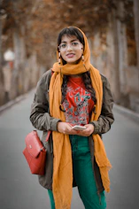 woman in gray coat and orange scarf