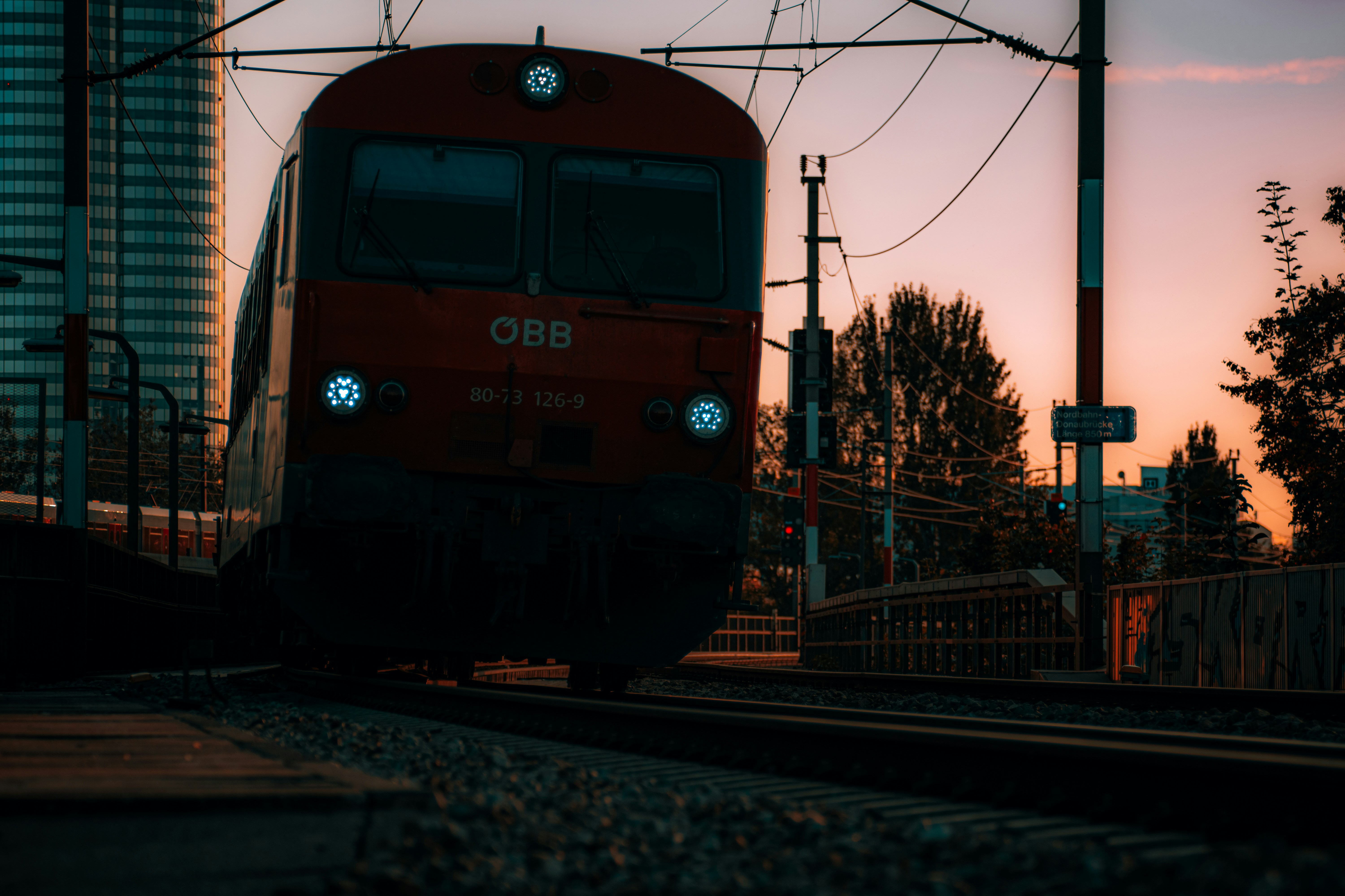 blue and red train on rail road during daytime