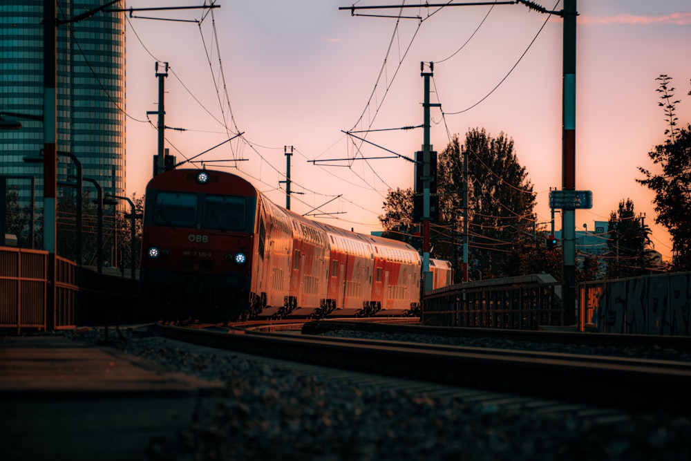 red and yellow train on rail tracks during daytime