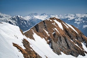 Mountain landscape with snow-capped peaks under a clear blue sky