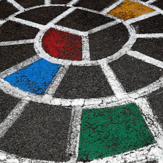 A freshly painted curb showing a custom flag design representing a local community group.