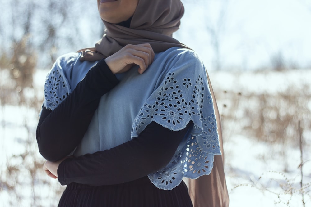 woman in blue hijab and white long sleeve shirt