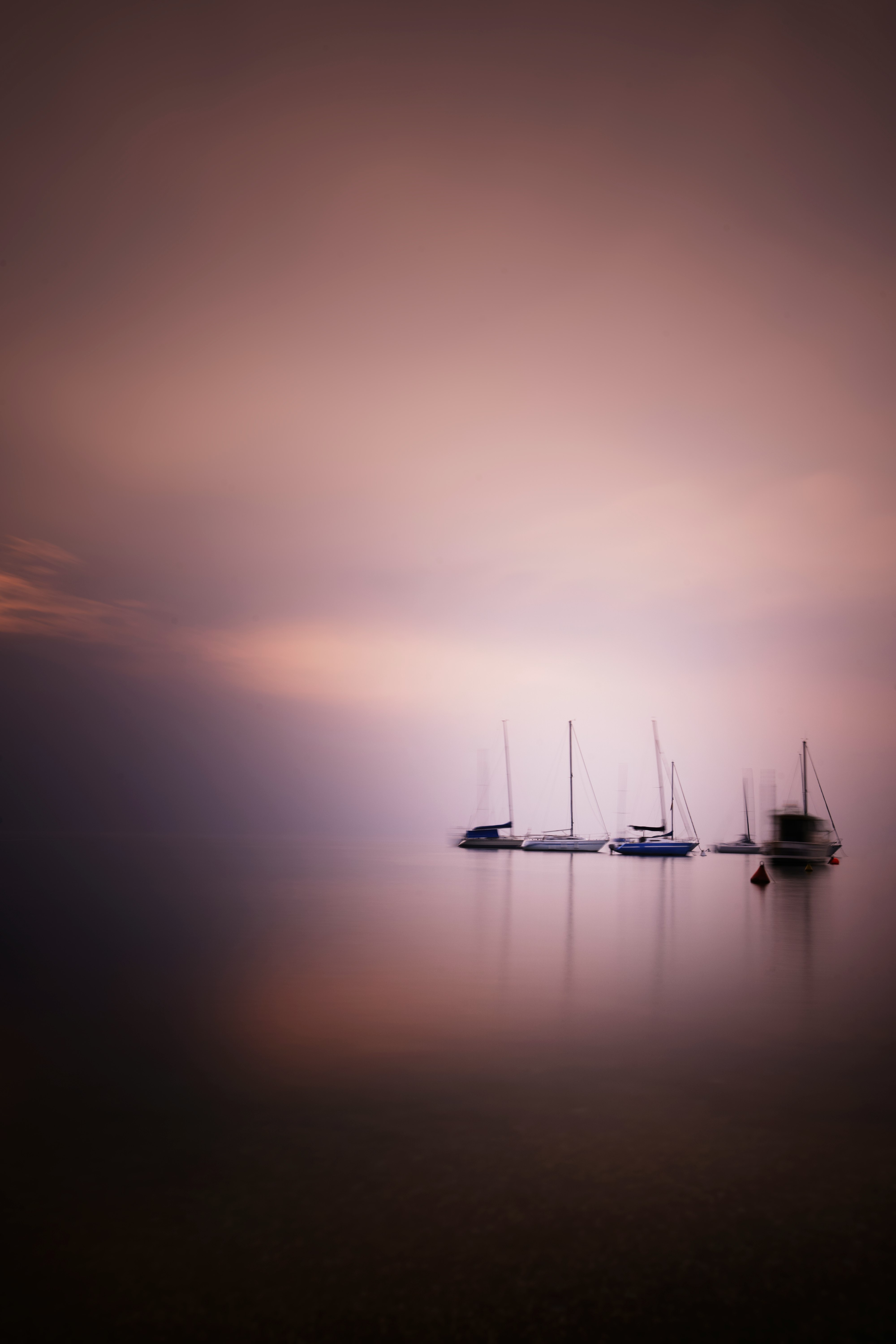 two boats on calm sea during sunset