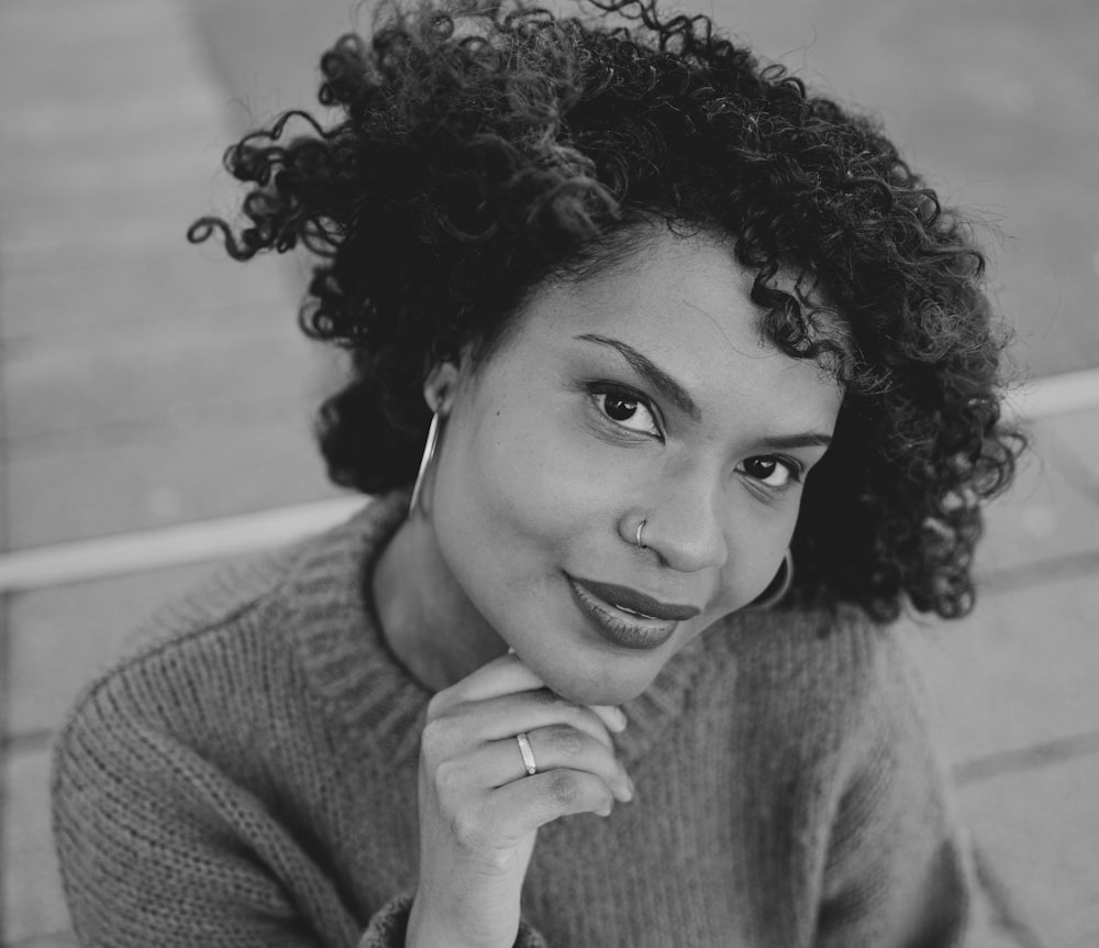 grayscale photo of woman in sweater