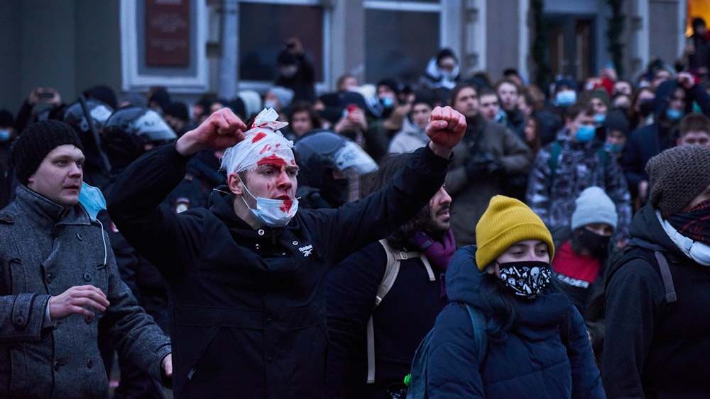 people in black jacket and yellow knit cap during daytime