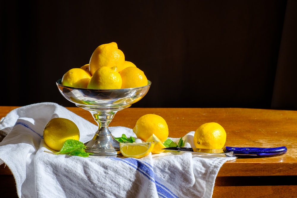 yellow lemon fruit on clear glass bowl
