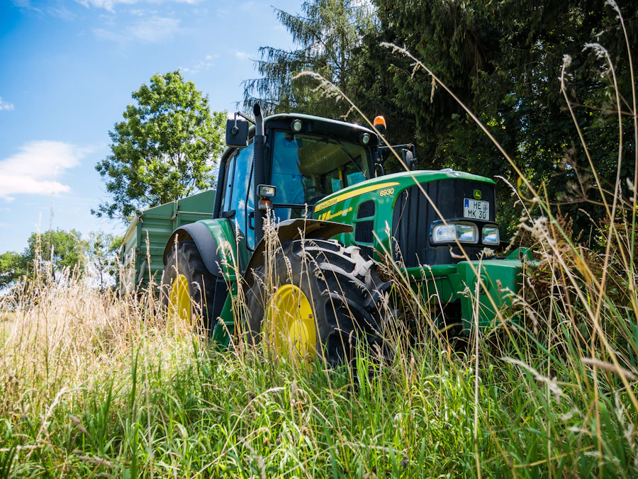 Green tractor standing in grass