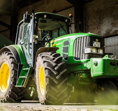 green and yellow tractor in garage