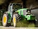 green and yellow tractor in garage