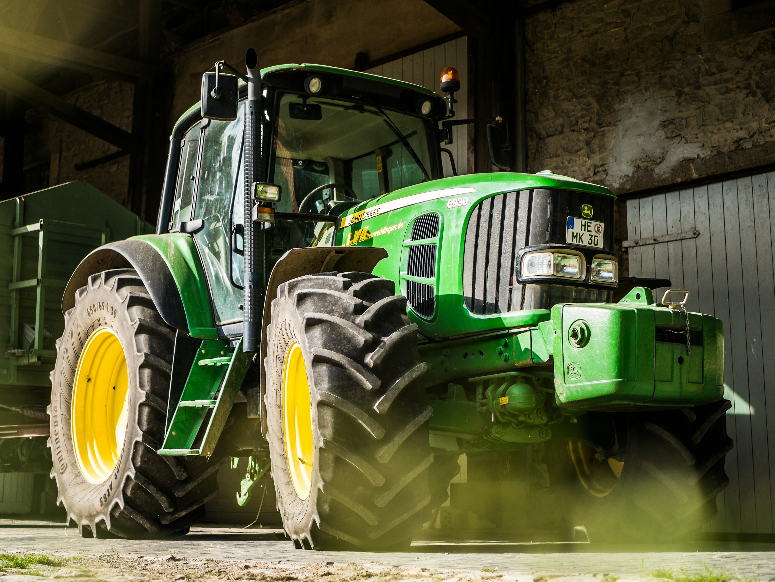 green and yellow tractor in garage