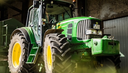 green and yellow tractor in garage