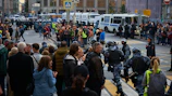 Police officers managing a crowd during a local protest in an urban area.