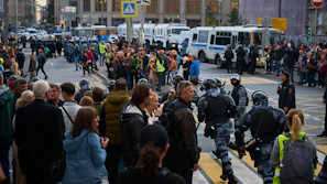 Police officers managing a crowd during a local protest in an urban area.