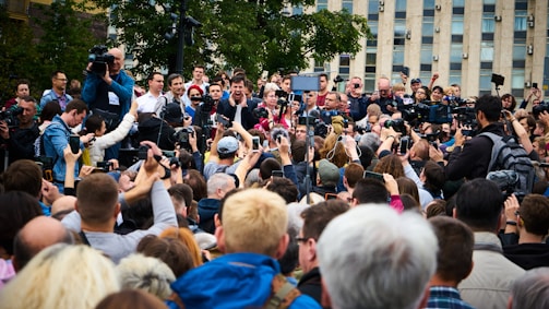A professional image of skhan engaging with media representatives at a global event.