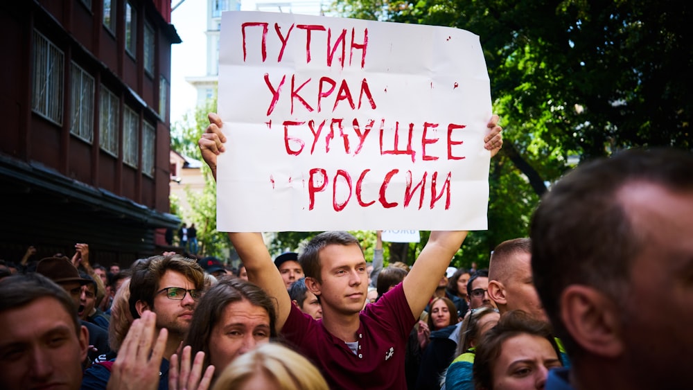 people holding white printer paper during daytime