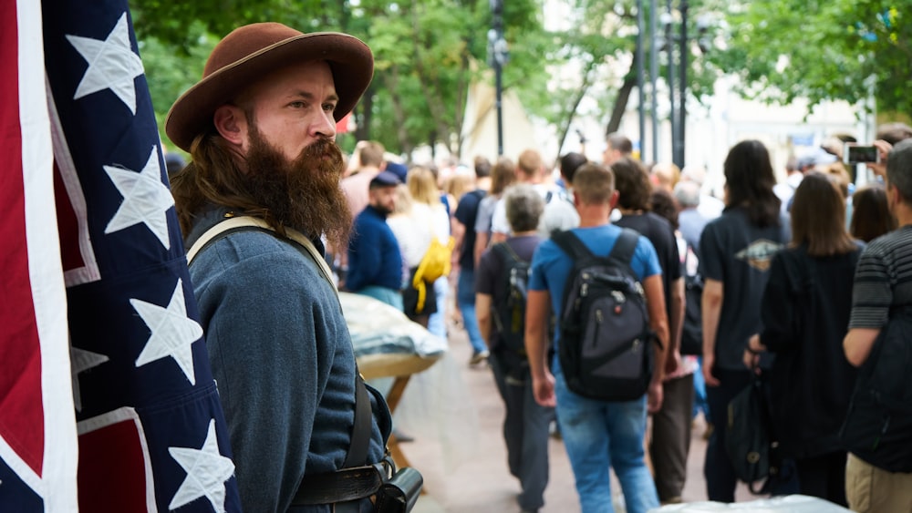 man in blue long sleeve shirt wearing brown hat