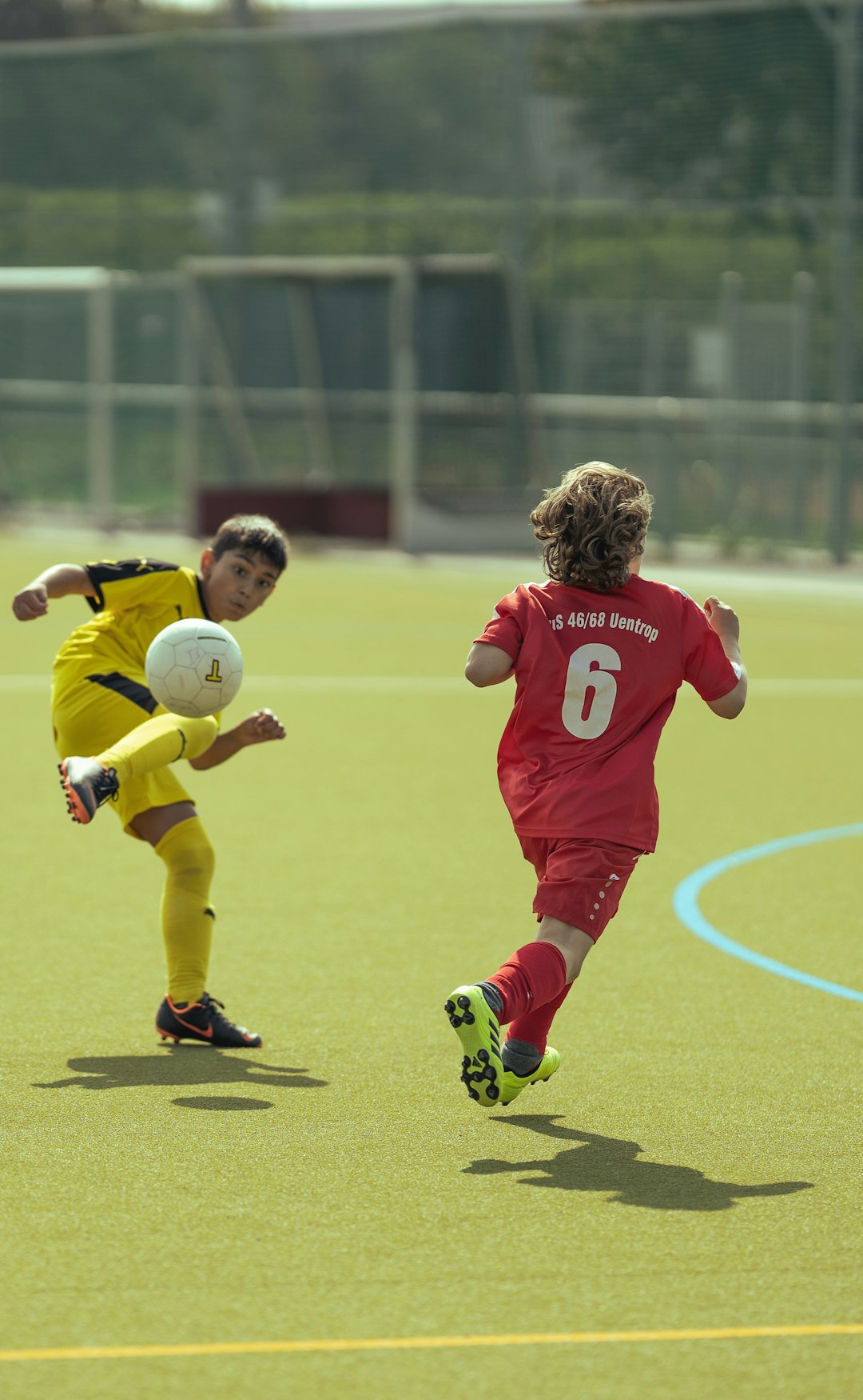 man in red and white soccer jersey kicking soccer ball