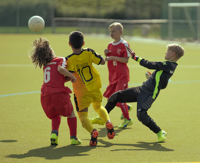 Youth soccer players on a green field during a school tournament