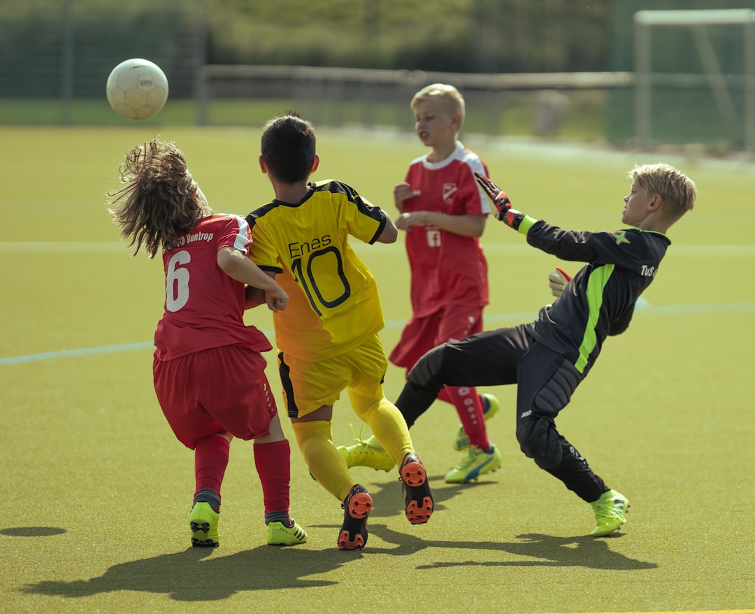 3 men in red and blue soccer jersey playing soccer