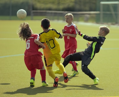 3 men in red and blue soccer jersey playing soccer