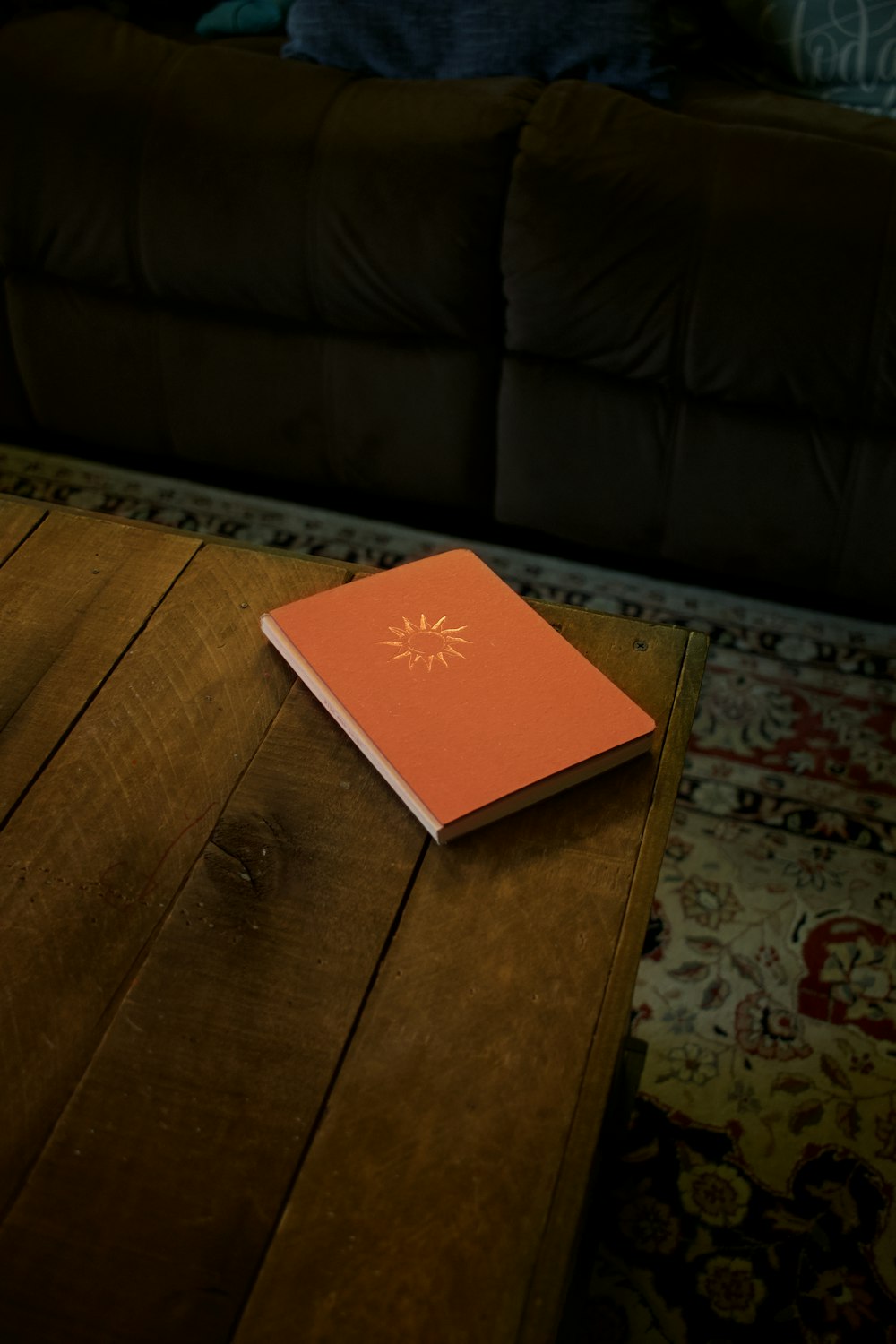 red and white book on brown wooden table
