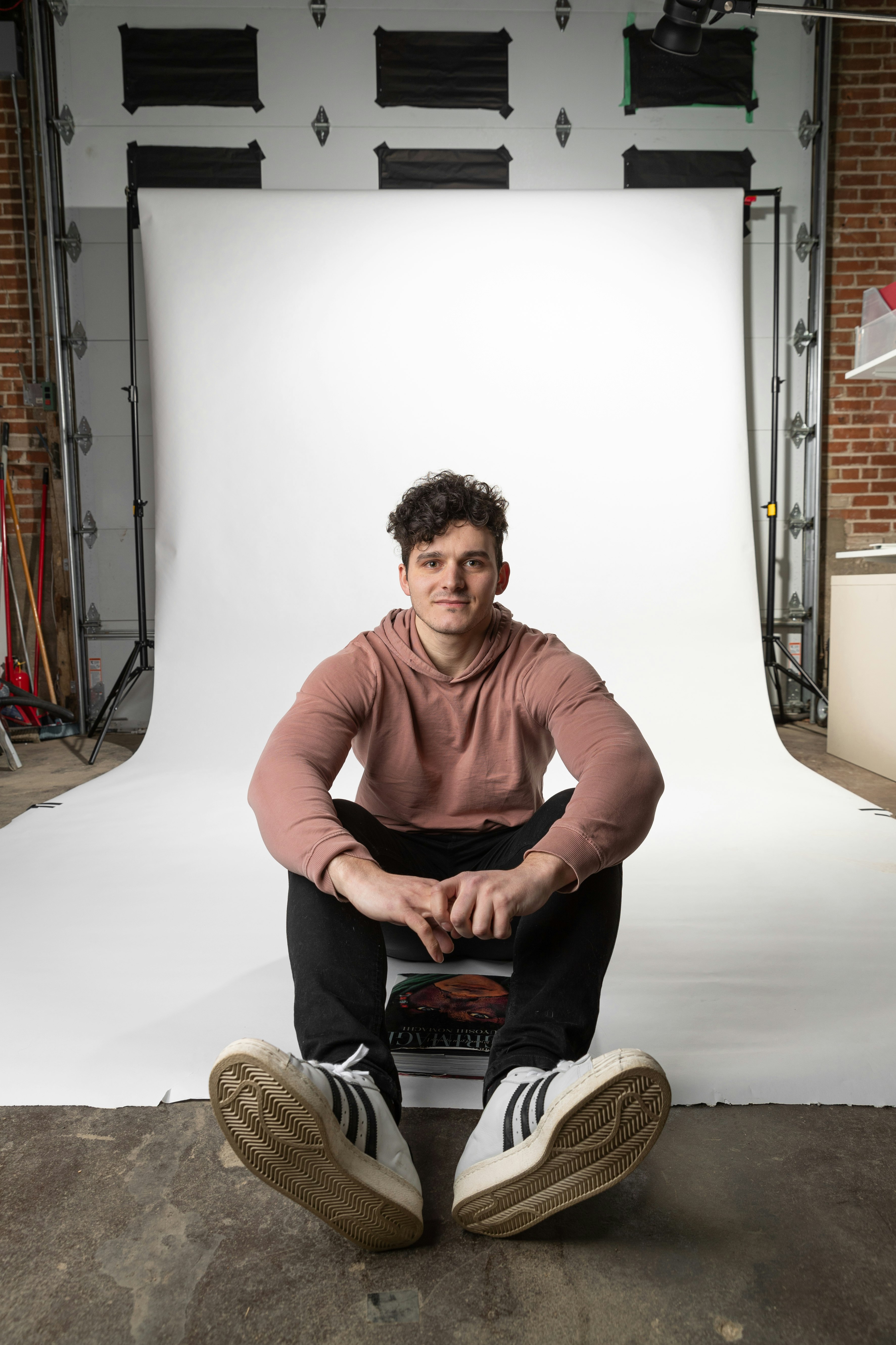 man in brown long sleeve shirt sitting on brown wooden seat