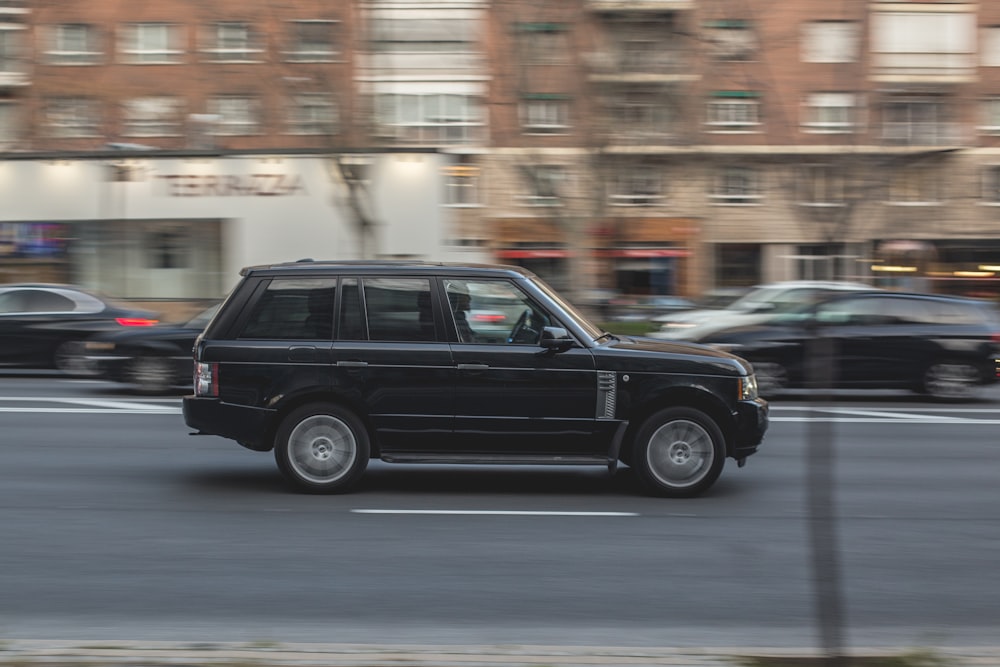 black suv on road during daytime