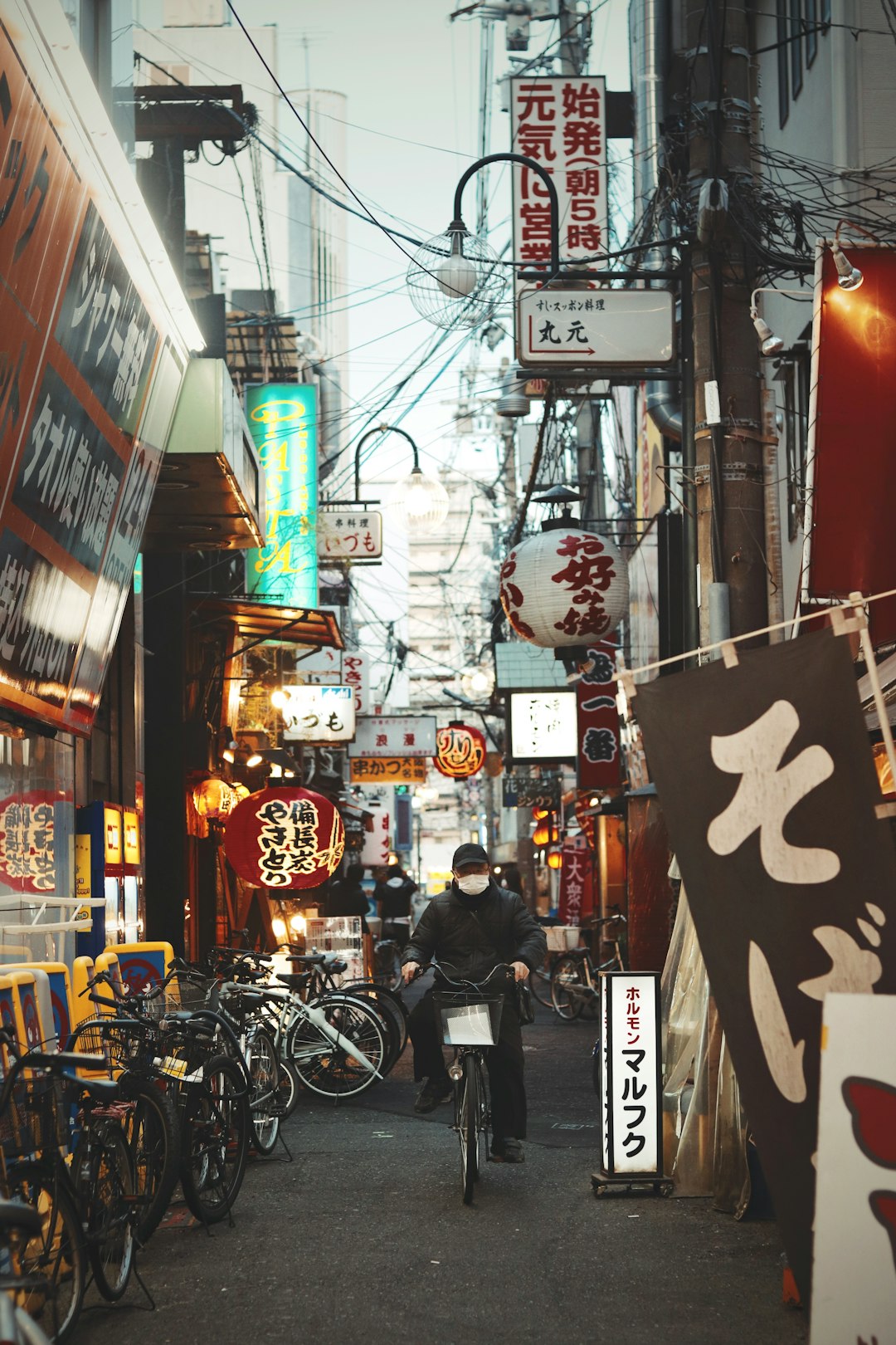 man in black jacket and black pants standing beside store