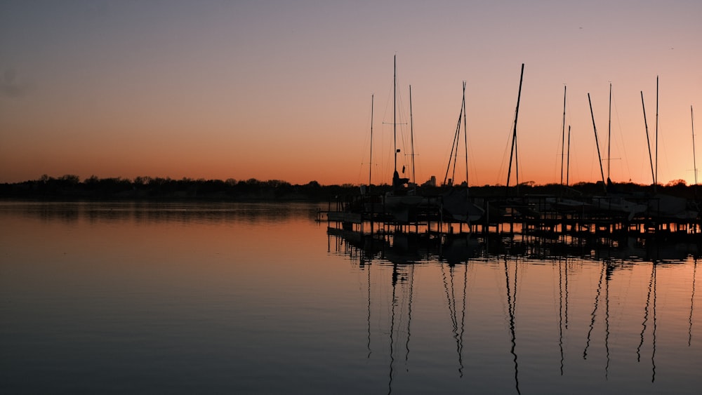 silhouette of boat on sea during sunset