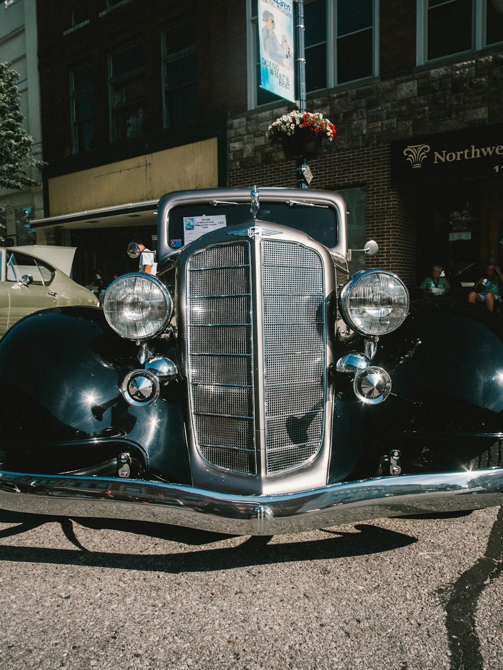 black classic car in front of building