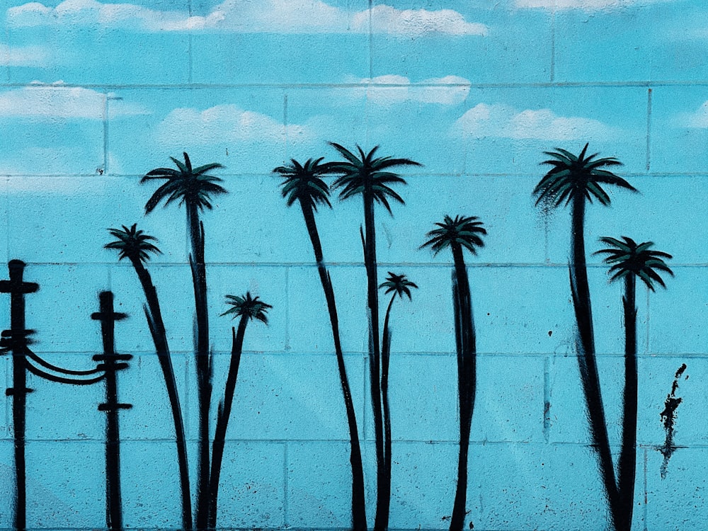black palm tree on gray brick wall