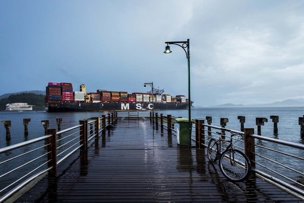 black bicycle on wooden dock during daytime