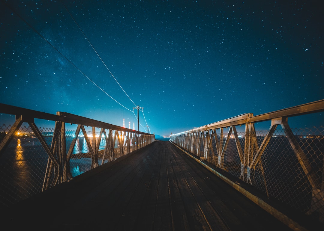brown wooden bridge under blue sky during night time