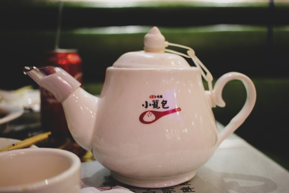 white ceramic teapot on white table