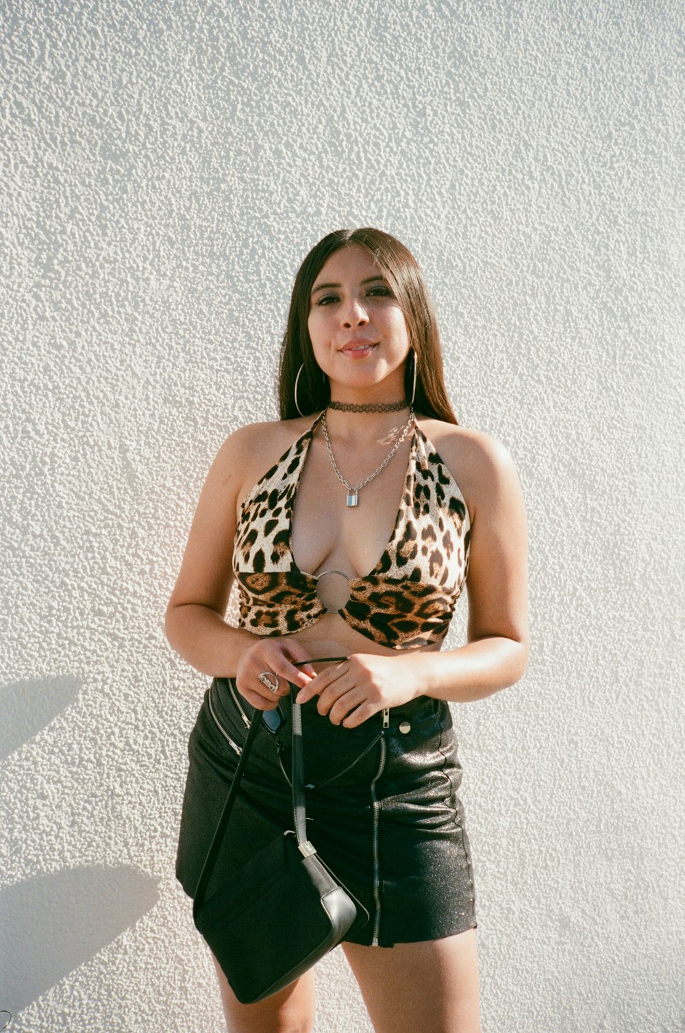 woman in black and brown leopard print tank top and black denim jeans