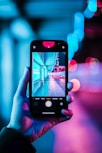 person holding iphone with black case