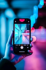 person holding iphone with black case