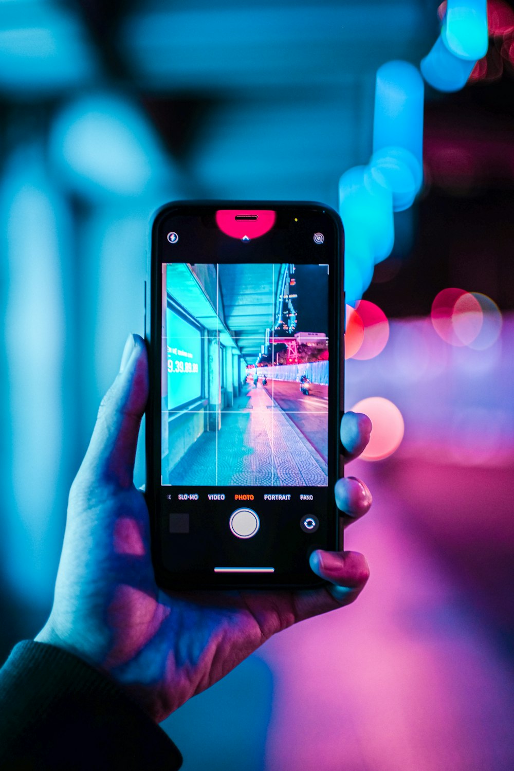 person holding iphone with black case