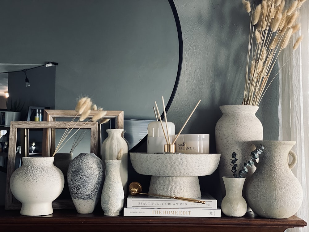 white ceramic vase on white wooden shelf