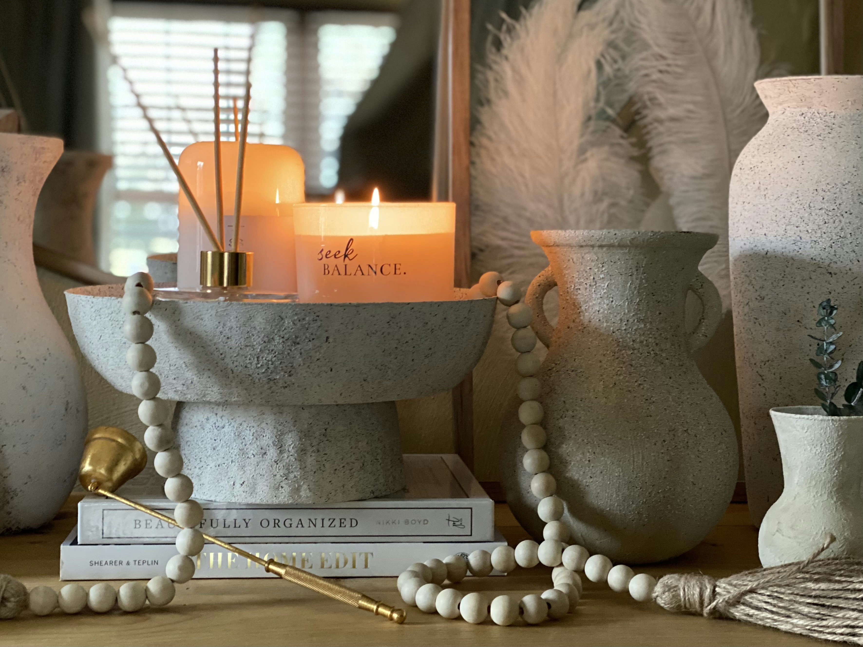 white pillar candles on gray steel candle holder, 