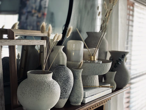 white ceramic vase on brown wooden table