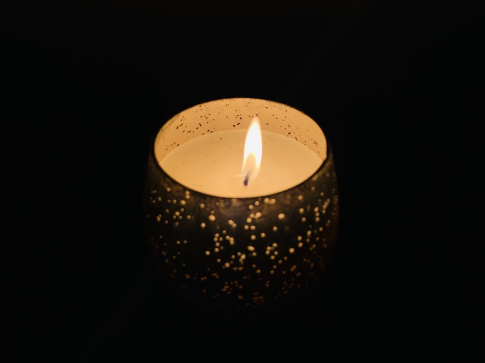 lighted candle in black background