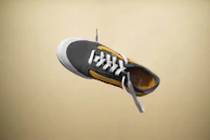 Dynamic shot of a sneaker mid-air, highlighting its bold design and vibrant colorway.