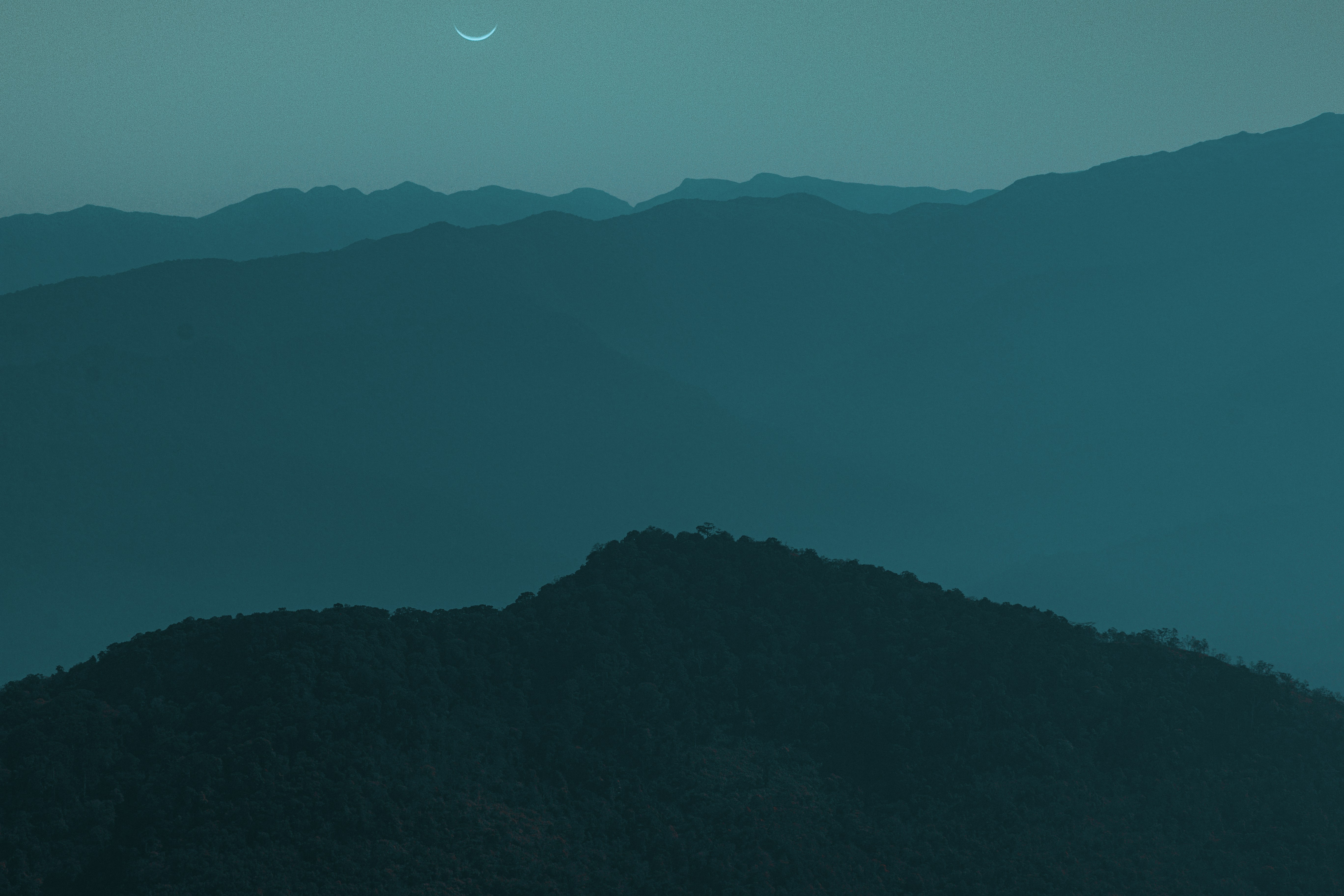 silhouette of mountain under blue sky during night time