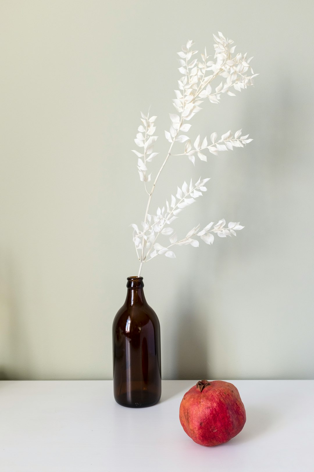 white flowers in brown glass bottle